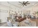 Cozy living room features hardwood floors, a large sectional sofa, an area rug and lots of natural light at 5203 Rushmere Ct, Palmetto, FL 34221