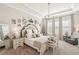 Inviting main bedroom featuring large windows, a tray ceiling, and tasteful decor at 5203 Rushmere Ct, Palmetto, FL 34221