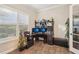 Home office featuring wood floors, a storage cabinet, and a window with plantation shutters at 5203 Rushmere Ct, Palmetto, FL 34221