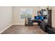 Office featuring wood floors, plantation shutters, and built-in desk and storage at 5203 Rushmere Ct, Palmetto, FL 34221
