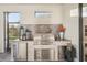 This outdoor kitchen features a built-in grill, mini fridge, and marble countertops at 5203 Rushmere Ct, Palmetto, FL 34221