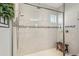 A tiled walk-in shower with glass enclosure, a shower bench, and a decorative tiled accent at 5203 Rushmere Ct, Palmetto, FL 34221