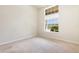 Neutral carpeted bedroom bathed in light from a large window at 5405 98Th E Ave, Parrish, FL 34219