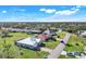 Aerial view of a single Gathering home in a residential neighborhood with mature landscaping and a pool at 566 Corrientes Cir, Punta Gorda, FL 33983