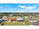An aerial view captures a neighborhood with mature trees and residential streets at 566 Corrientes Cir, Punta Gorda, FL 33983