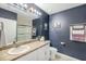 A full bathroom with a vanity, sink, toilet, and shower has plenty of lighting and mirrors at 566 Corrientes Cir, Punta Gorda, FL 33983