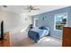 Serene bedroom with natural light, neutral walls, and views of the backyard pool at 566 Corrientes Cir, Punta Gorda, FL 33983