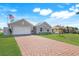 Charming single Gathering home featuring a two-car garage and lush green lawn at 566 Corrientes Cir, Punta Gorda, FL 33983