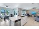 Spacious kitchen with a center island, stainless steel dishwasher, and views of the outdoor pool area at 566 Corrientes Cir, Punta Gorda, FL 33983