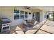 An outdoor dining set sits on a screened-in lanai with tiled floor and outdoor grill at 566 Corrientes Cir, Punta Gorda, FL 33983