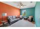 Vibrant living room with stylish wicker furniture, contrasting walls and carpeted floor at 566 Corrientes Cir, Punta Gorda, FL 33983
