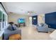 Bright living room featuring tile floors, ceiling fan, and comfortable seating arrangements at 566 Corrientes Cir, Punta Gorda, FL 33983