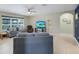 Comfortable living room with tile floors, plenty of sunlight, and a ceiling fan at 566 Corrientes Cir, Punta Gorda, FL 33983