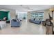 Spacious living room with tile flooring, lots of seating, and a view of the kitchen at 566 Corrientes Cir, Punta Gorda, FL 33983