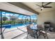 A screened-in lanai features an outdoor dining area, a barbeque, and a sparkling pool at 566 Corrientes Cir, Punta Gorda, FL 33983