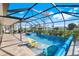 Screened-in swimming pool with lounge chairs and a hot tub for relaxing outdoor living at 566 Corrientes Cir, Punta Gorda, FL 33983