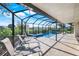 An inviting screened in swimming pool and lanai, perfect for outdoor lounging and relaxation at 566 Corrientes Cir, Punta Gorda, FL 33983
