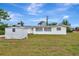 Spacious backyard view featuring a shed, grassy lawn, and white single-story home at 610 Cumberland Rd, Venice, FL 34293