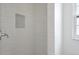 Updated shower showcasing subway tile and mosaic tile niche for storage at 610 Cumberland Rd, Venice, FL 34293