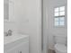 Well-lit bathroom featuring a vanity, toilet, and tiled walk-in shower at 610 Cumberland Rd, Venice, FL 34293