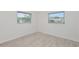 This bright bedroom offers wood-look flooring and natural light from two windows at 610 Cumberland Rd, Venice, FL 34293