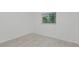 Bright bedroom features wood-look flooring and a window providing natural light at 610 Cumberland Rd, Venice, FL 34293