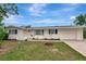 Charming single-story home with a manicured lawn, a white exterior, and a well-lit doorway at 610 Cumberland Rd, Venice, FL 34293