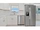 Bright kitchen featuring stainless steel appliances, white cabinets, and modern finishes at 610 Cumberland Rd, Venice, FL 34293