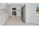 Modern kitchen features stainless steel appliances, white cabinets, and new flooring at 610 Cumberland Rd, Venice, FL 34293