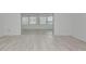 Bright living room showcases open floor plan and wood plank floors at 610 Cumberland Rd, Venice, FL 34293