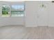 Bright living room showcasing new flooring, natural light, and a welcoming front entrance at 610 Cumberland Rd, Venice, FL 34293