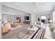Bright living room featuring neutral decor, ceiling fan, and an open layout with updated flooring at 610 Cumberland Rd, Venice, FL 34293