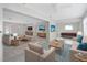 Bright living room featuring neutral decor, ceiling fan, an open layout, and updated flooring at 610 Cumberland Rd, Venice, FL 34293