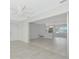 Bright room featuring sleek flooring and an open entrance to the kitchen at 610 Cumberland Rd, Venice, FL 34293