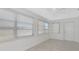 Bright sun room featuring tile floors, three windows, blinds, and a ceiling fan at 610 Cumberland Rd, Venice, FL 34293