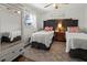 Bright bedroom with twin beds, decorative pillows, and natural light from window at 6125 Coral Way, Bradenton, FL 34207