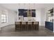 Stunning kitchen features a large island with bar seating, sleek stainless steel appliances, and modern pendant lighting at 6137 Grove Blvd, Punta Gorda, FL 33982