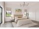 Bright and airy main bedroom with large windows, neutral tones, and modern chandelier at 6137 Grove Blvd, Punta Gorda, FL 33982