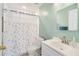 Fresh bathroom featuring a shower-tub combo, bright vanity, and a blue accent wall at 6320 Rosefinch Ct # 101, Lakewood Ranch, FL 34202