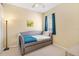 Sunny bedroom with blue daybed, carpet, and neutral walls at 6320 Rosefinch Ct # 101, Lakewood Ranch, FL 34202