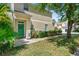 Inviting two-story condo with a well-manicured lawn and a welcoming green front door at 6320 Rosefinch Ct # 101, Lakewood Ranch, FL 34202