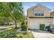 Attractive condo featuring an attached two-car garage and well-kept landscaping at 6320 Rosefinch Ct # 101, Lakewood Ranch, FL 34202