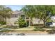 Lovely condo exterior boasting a quaint balcony, a green entry door, and mature trees at 6320 Rosefinch Ct # 101, Lakewood Ranch, FL 34202