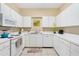 Efficient kitchen featuring white cabinets and ample counter space for meal preparation at 6320 Rosefinch Ct # 101, Lakewood Ranch, FL 34202