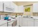 Cozy kitchen featuring white cabinetry and modern appliances at 6320 Rosefinch Ct # 101, Lakewood Ranch, FL 34202