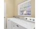 Bright laundry room features a Maytag washer and dryer, and natural light from a window at 6320 Rosefinch Ct # 101, Lakewood Ranch, FL 34202