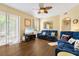 Inviting living room boasts hardwood floors, stylish decor, and sliding glass doors for natural light at 6320 Rosefinch Ct # 101, Lakewood Ranch, FL 34202