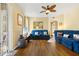 Charming living room featuring hardwood floors, ceiling fan, and comfortable blue sofas at 6320 Rosefinch Ct # 101, Lakewood Ranch, FL 34202
