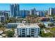 Stunning aerial shot showcases modern condo building with city and water views in the background at 635 S Orange Ave # 404, Sarasota, FL 34236
