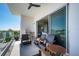 Outdoor seating area on condo balcony with ceiling fan and views at 635 S Orange Ave # 404, Sarasota, FL 34236